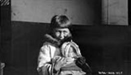 The chap holding the baby is the son of the late William Carron - Bernier's nephew and Atagooshie of Pond Inlet. 1928