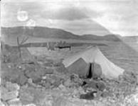 [Inuit campsite with a tent and kayak] Original title: Native camp. 7 September 1928.