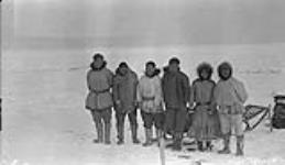 Natives from Nunaluk, S.W. of Herschel Island. One arm John and wife to extreme right  March 1927.