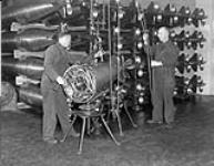 Personnel servicing torpedoes at the Royal Canadian Navy (R.C.N.) Torpedo Depot, Halifax, Nova Scotia, Canada, March 1941. March 1941.