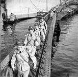 Personnel of the Canadian Women¿s Army Corps (C.W.A.C.) disembarking from a troopship at Naples, Italy, 22 June 1944. June 22, 1944.