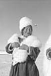 Inuit woman wearing fox furs and hat May 1951.