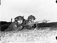Private L.H. Johnson and Sergeant D.R. Fairborn of the 1st Canadian Parachute Battalion with a PIAT anti-tank weapon, Lembeck, Germany, 29 March 1945. March 29, 1945.