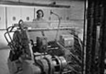 Worker operating warper at Montreal Cottons Ltd. c.a. Mar. 1942