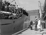 Netherlands Ambassador Dr. J.H. van Roijin and Mrs. van Roijin greeting Dutch immigrants arriving by ship in Montreal. June 1947