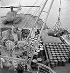 Unloading oil drums at Coral Harbour from the Canadian Government Ship C.D. Howe on Eastern Arctic Patrol. [July 1951.]. July 1951.