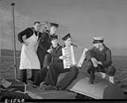 Personnel taking part in singsong aboard unidentified patrol vessel of the Fishermen's Reserve. 6 Nov 1941