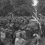 Canadian Army troops being cheered by Dutch civilians along route taken during Liberation of the Netherlands. 7 May 1945