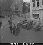 Various Allied officers, German officers, and Dutch civilians in the square at the time of discussion of food distribution to the Dutch population. 2 May 1945