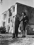 Signora Maria Theresa Berardi and Signor Guido Berardi standing in front of Casa Berardi, 200 year old fortified house at which Major Paul Triquet won the Victoria Cross. 13 Mar. 1944
