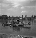 M3 half-track vehicle crossing the Seine River on a pontoon raft. 27 Aug. 1944