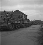 Line of Stuart and Sherman tanks waiting to cross the bridge. 28 Aug. 1944