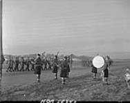 Pipers in foreground as the Highlanders Light Infantry marches by. 30 Nov. 1945