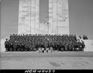 The massed pipe bands with Gen. H.D.G. Crerar grouped in front of the Memorial monument during the 28th Anniversary Ceremony of the Battle of the Vimy Ridge. 9 Apr. 1945