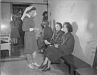 H.M.C.S. CONESTOGA, nursing sisters prepare new entry Wrens for their medical. July 1943. JULY 1943