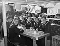 Unidentified ratings eating a meal aboard H.M.C.S. AGGASIZ, Esquimalt, British Columbia, Canada, February 1941. February 1941.