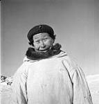 Inuit man wearing caribou or duffle parka and living in the area between Provungnituk and Poste-de-la-Baleine. Jan. 1946.