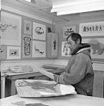 Pudlo, Inuit artist, in the art centre, Cape Dorset, N.W.T., [ (Kinngait), Nunavut], August 1961. August 1961.