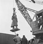 Statue of Sir Robert Borden, Parliament Hill, being lowered into place. Sept. 1956