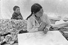 Kenojuak drawing inside her tent, Cape Dorset, N.W.T., [ (Kinngait), Nunavut], August 1960. August 1960.