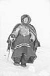 Inuit woman with cane, wearing a shawl and parka  1947-1948.