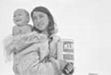 A child and the mother holding a gift. (Can of powdered milk) 1951.