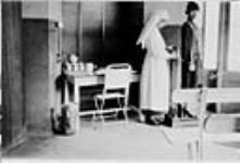 Nursing sister treating soldier. c 1916