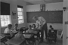 Classroom of Laidley Spring School on the Matador Co-operative farm about 40 miles north of Swift Current, Sask.  Teacher is R. L.Moen. Sept. 1952
