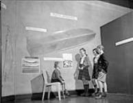 Design in Industry Exhibition - youngster tries plastic chair. Oct. 1946