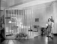Design in Industry Exhibition - visitors inspect model room. Oct. 1946