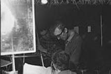 Norman McLaren, film creator at the National Film Board, discussing the animated film Le Merle with Maurice Blackburn (?) and Evelyn Lambart (?) Feb. 1958