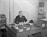 Lt.Comm. Roland Bourke, V.C. at his office desk, H.M.C.S. Esquimalt. 16 May 1941