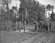 1st CANADIAN ARMY IN FRANCE. Prince Bernhard of the Netherlands takes the general salute under the Canadian and Dutch flags during his visit of Dutch troops in Normandy. 23 Aug. 1944