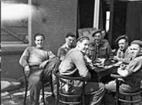 Infantrymen of the 1st Canadian Infantry Division resting after liberating Apeldoorn, Netherlands, 17 April 1945 Apri1 17, 1945.