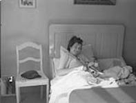 The child born during the 1st Cdn Division arty bombardment (14 April). Albert Johan Maria Spook and his mother. 20 Apr. 1945