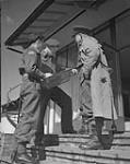 Lt. J.K. Heath, Lt. Col. George Renison and Major Bert S. Wemp of the Hastings and Prince Edward Regiment on the steps of the headquarters. 19 Apr. 1945