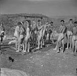 Mobile shower in operation by the Saskatchewan Light Infantry. 18 Aug. 1943