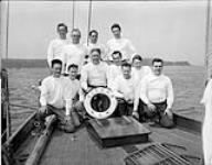 Crew of RCN yacht PICKLE: front (l.-r.) AB James R. MacFarlane;Lt J.G.R. Hutcheson;Cdr G.M. Wadds;AB Daniel P. Smith;Cdr A.B. Rivers;S/Lt. P.T. Johnson;Cdr D.A. Collins; back: Halifax Mayor LeonardA. Kitz;Capt T.F.T. Morland;Lt. E.A. Wiggs; unide. 02-Jul-55