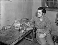 German prisoner-of-war working in model-making shop at Camp 32. 8 Feb. 1946