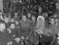 General H.D.G. Crerar with St. Nicholas (Lieutenant H.J. Tingle) and children during a Christmas party at First Canadian Army Main Men's Mess. 24 Dec. 1944