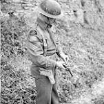 Sergeant W.A. Seibel of the Saskatoon Light Infantry (M.G.) loading his revolver, Italy, 8 March 1944. March 8, 1944