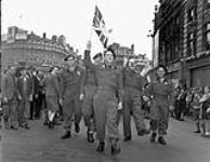 Canadian soldiers celebrating V-E Day, Piccadilly Circus, London, England, 8 May 1945. May 8, 1945