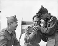 l Canadian Navy Beach Commando "W", talking with Private M. Belanger ((left) and Corporal P. Jenkins of Le Régiment de la Chaudière in the Juno sector of the Normandy beachhead, France, 20 July 1944  July 20, 1944