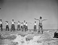Personnel of W-2 Party, Royal Canadian Navy Beach Commando "W", exercising under the  direction of Petty Officer Douglas E. McIntyre in the Juno sector of the Normandy beachhead, France, 20 July 1944  July 20, 1944
