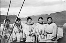 Inuit girls come aboard to visit us at "Pang". [Left to right: Rosie Okpik, Pheobe Qupi, Annie Maniapik, Ida Qaqqasiq, and Evie Pilattuaq.]. ca. 1950 - 1959