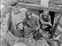 Forcemen of  3-1, First Special Service Force,  in an M-2 60mm mortar pit, Anzio beachhead, Italy, ca. 20-27 April 1944. ca. April 20-27, 1944.