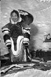 Interior view of an igloo with Inuit woman [Hiquatnaaq]  1948-1953.