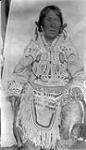 Inuit woman in decorated clothing [Pittau wearing an amauti] 
