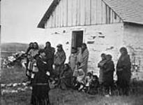 Group of First Nations adults and children at an unidentified school house, Alberta, unknown date n.d.