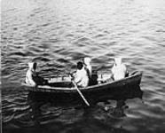 Four Inuit men in a boat at Port Burwell, Northwest Territories [Killiniq, Nunavut], July 25-31, 1904 between July 25-31, 1904.